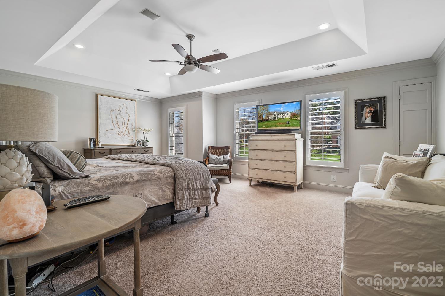 4612 Binfords Ridge Road Charlotte, NC 28226 - Photo 39 of 48 a spacious bedroom with a bed a couch and a walk in closet