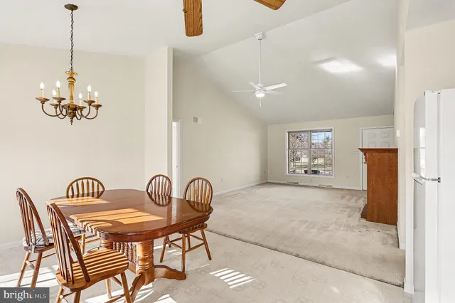 a view of a dining room with furniture and chandelier