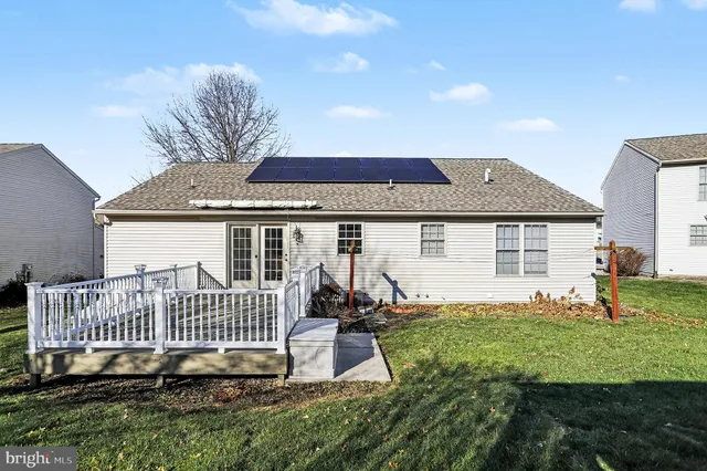 a view of a house with a yard and deck