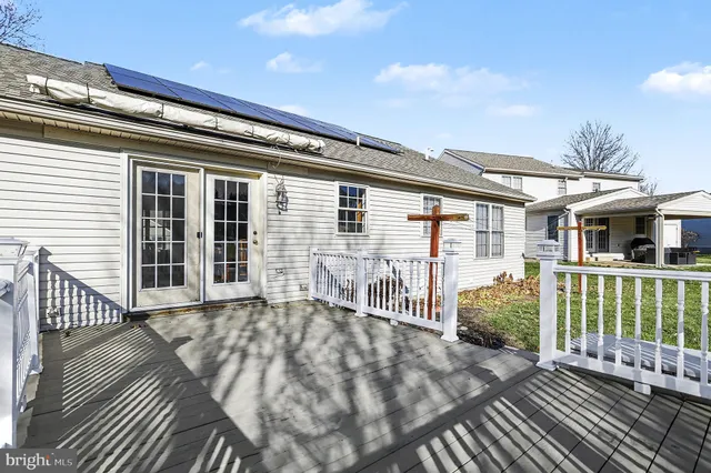 a view of a house with wooden deck