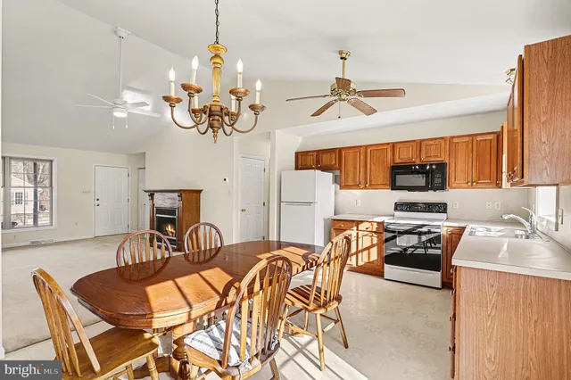 a view of a dining room with furniture a chandelier and wooden floor