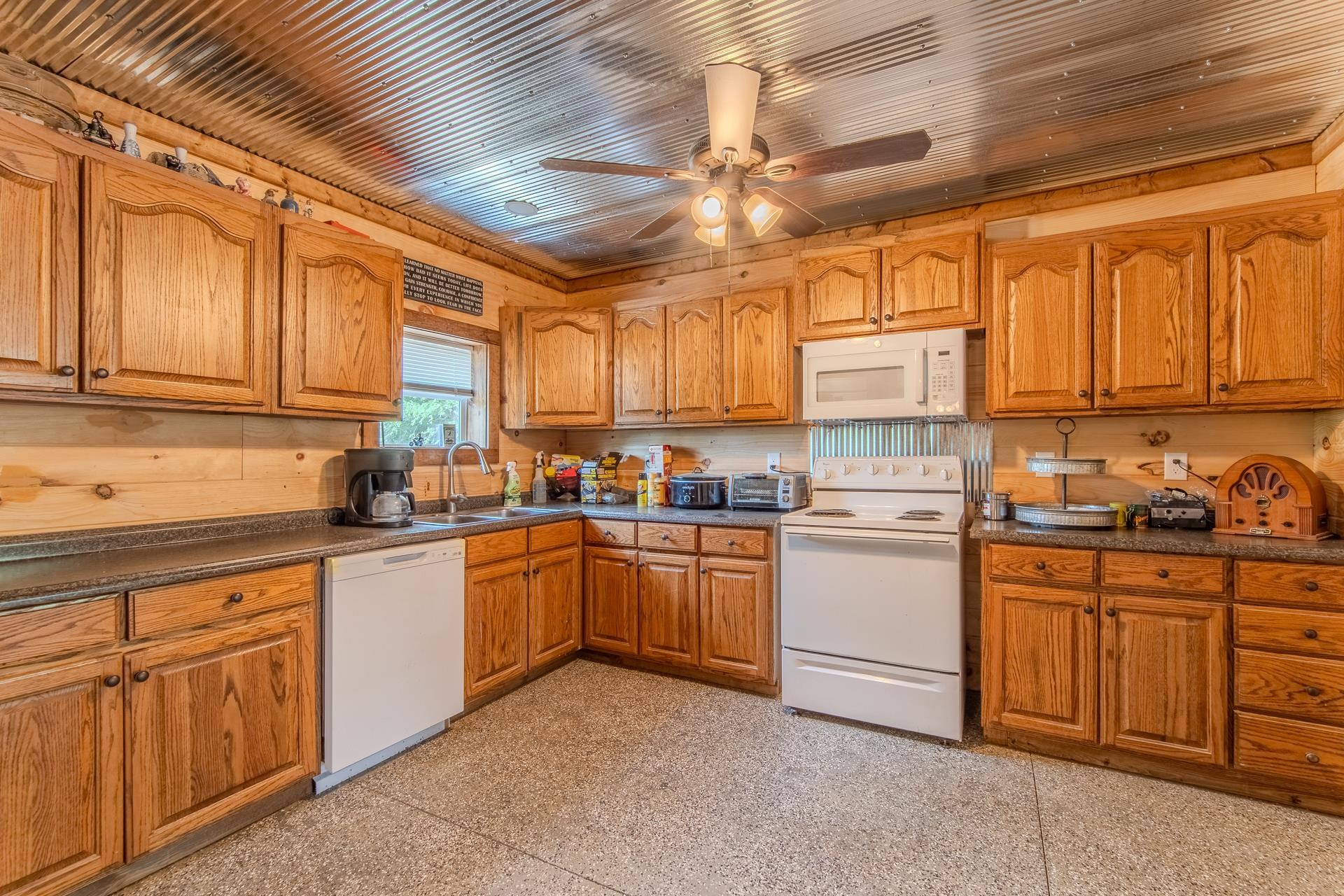 597 Hardin Graveyard Road Adamsville, TN 38310 - Photo 18 of 40 a kitchen with sink cabinets and window