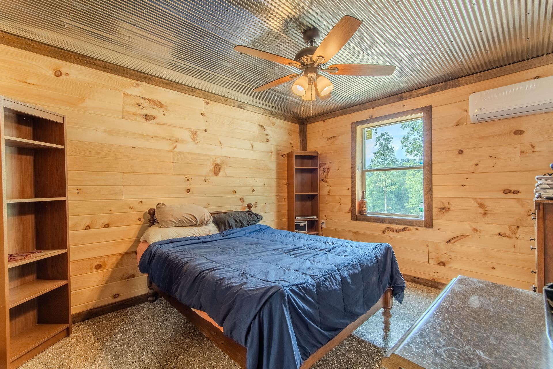 597 Hardin Graveyard Road Adamsville, TN 38310 - Photo 37 of 40 a bedroom with a bed and a chandelier