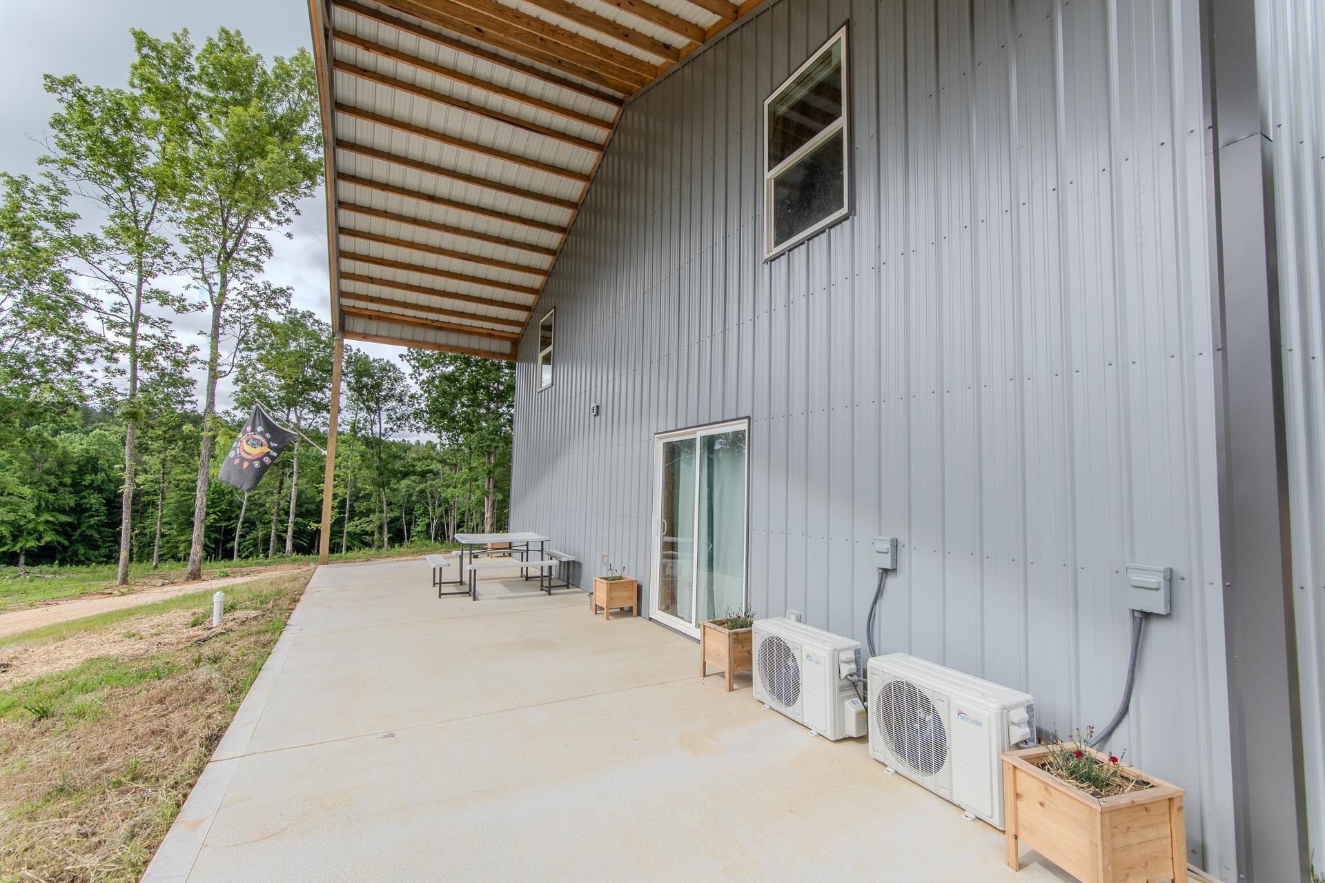 597 Hardin Graveyard Road Adamsville, TN 38310 - Photo 39 of 40 a patio with table and chairs and potted plants