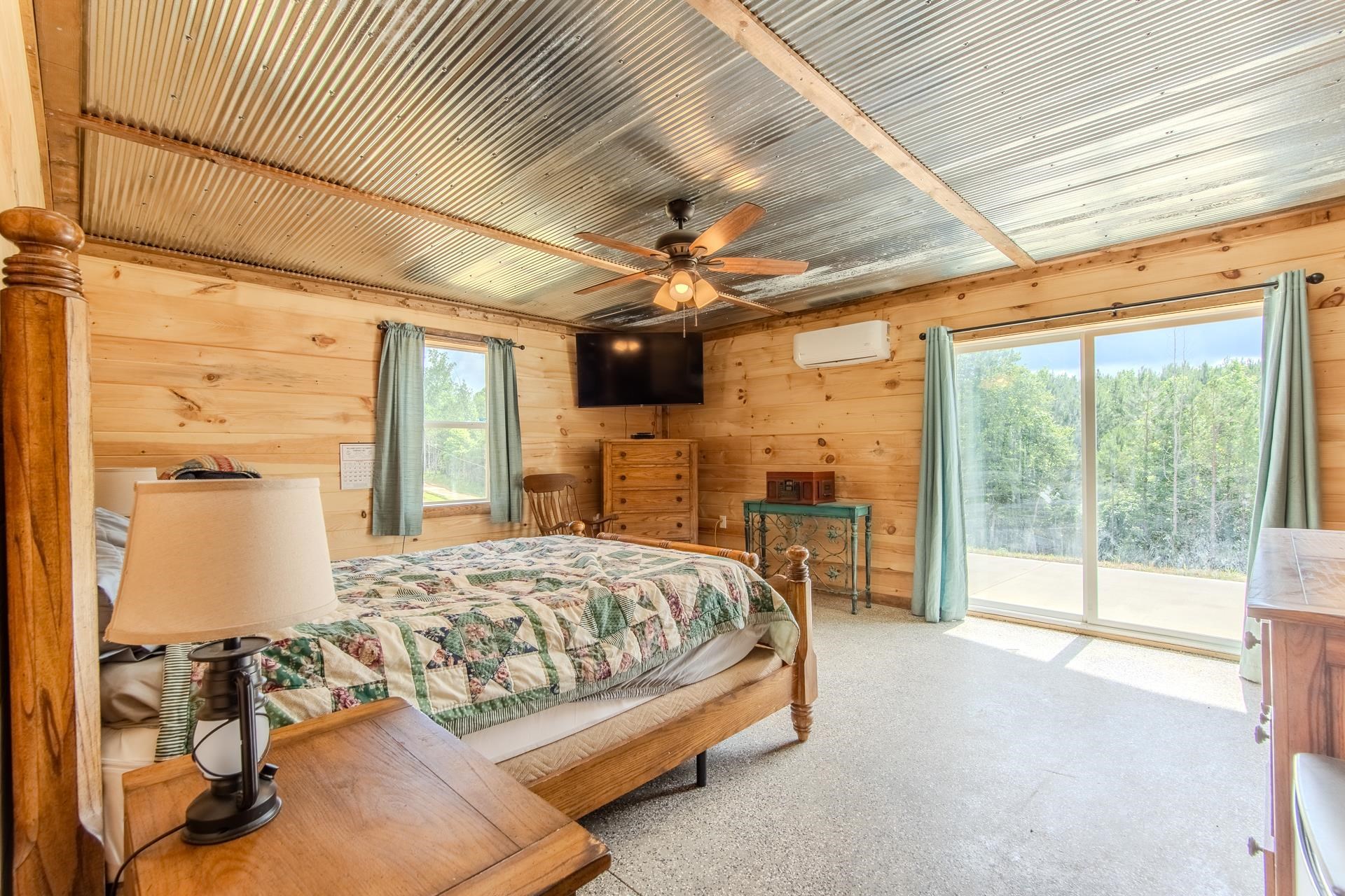 597 Hardin Graveyard Road Adamsville, TN 38310 - Photo 8 of 40 a spacious bedroom with a bed and a chandelier