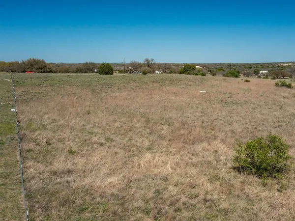a view of a field with an ocean