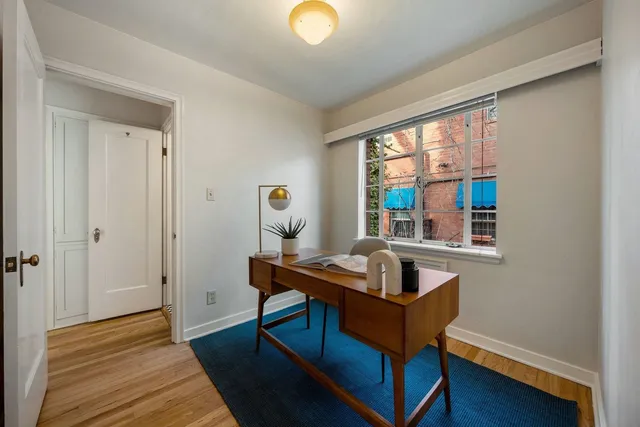 a room with wooden floor and a window