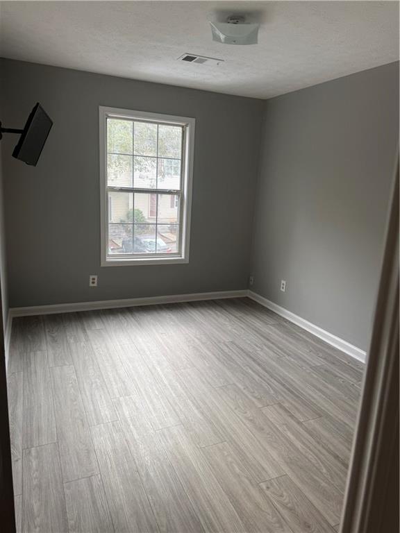 6341 Wedgeview Drive Tucker, GA 30084 - Photo 18 of 26 an empty room with wooden floor and windows
