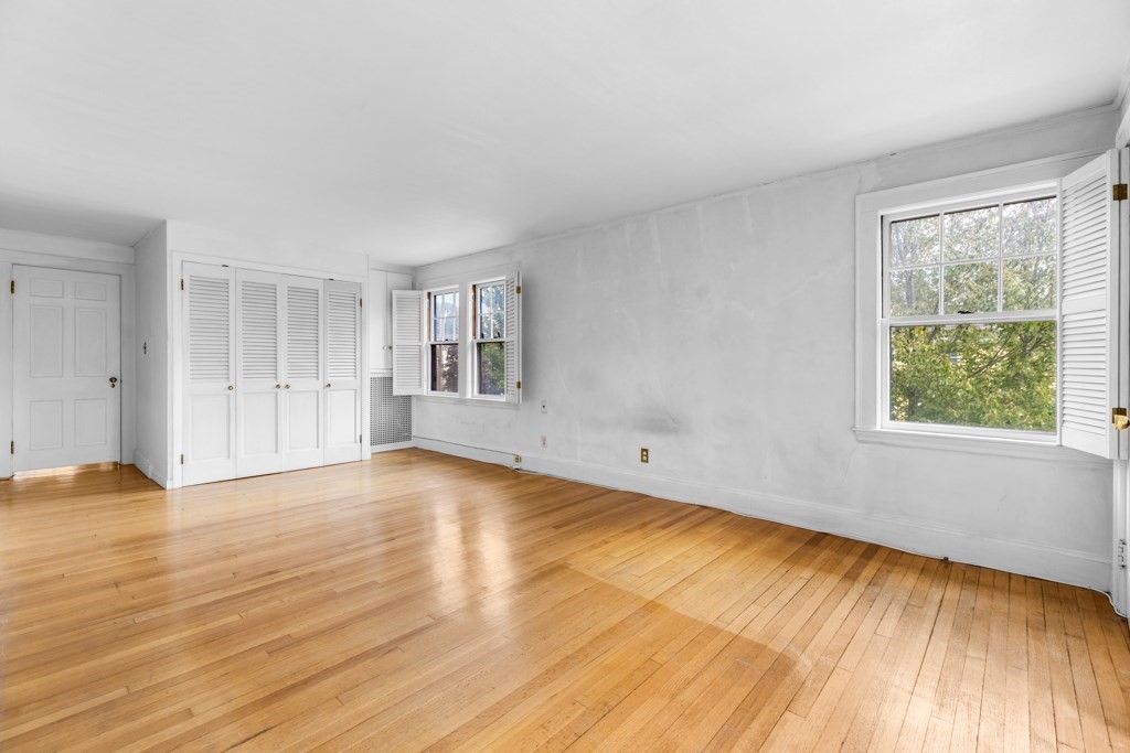 91 Standish Road Watertown, MA 02472 - Photo 17 of 33 a view of empty room with wooden floor and fan
