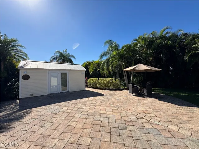 a front view of house with yard and trees