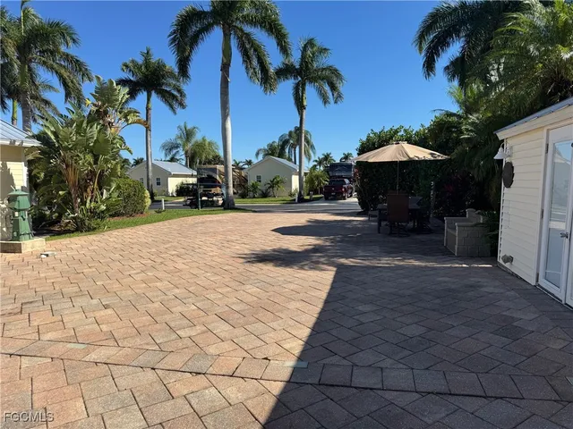 a row of palm trees in front of house