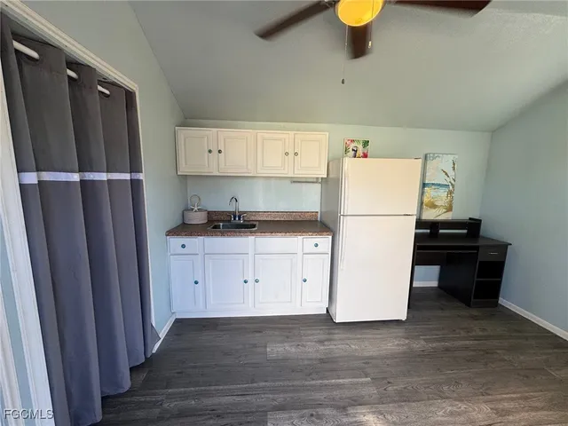 a kitchen with a refrigerator and a stove