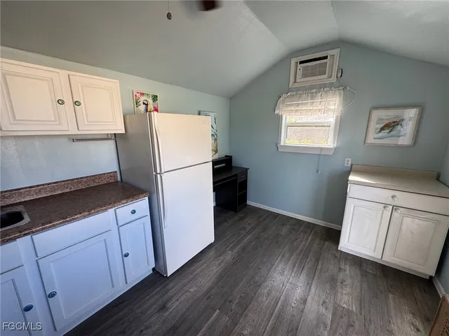 a kitchen with a refrigerator and a stove top oven