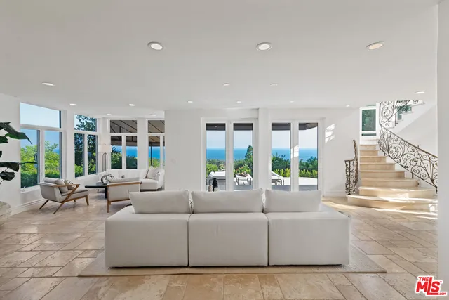 a view of a patio with couches and a big yard