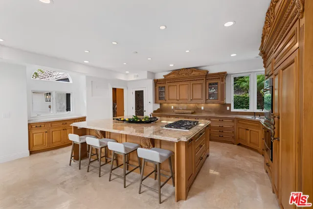 a dining room with furniture a chandelier and windows