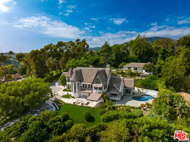 a view of a house with a yard and sitting area