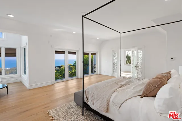 a spacious bathroom with double vanity and mirrors