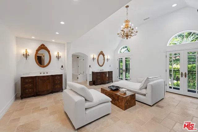 a living room with a bed furniture and a potted plant