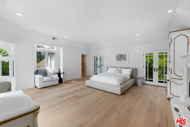 a kitchen with stainless steel appliances a table and chairs in it