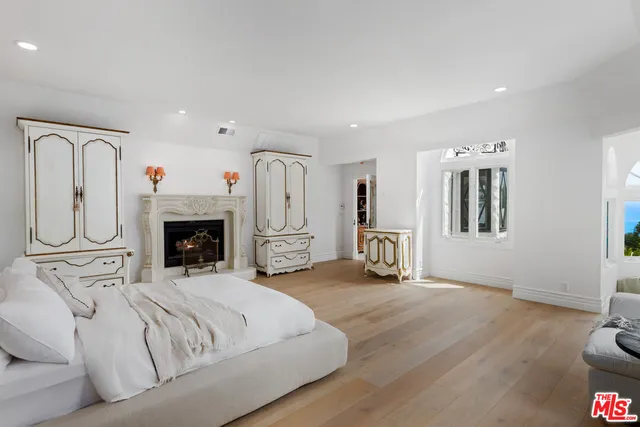 a dining room with furniture wooden floor a rug and a painting