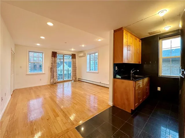 a kitchen with stainless steel appliances granite countertop a refrigerator a sink and a stove