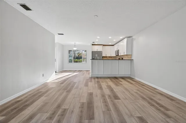 a view of kitchen and wooden floor