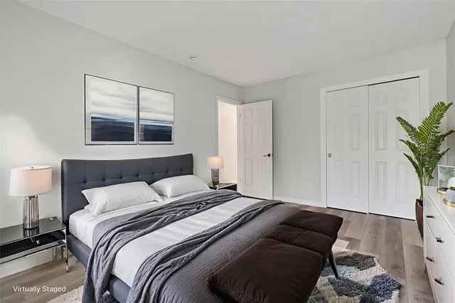 a bedroom with a bed and a potted plant