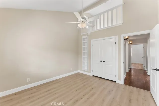 a view of a livingroom with a hall and a ceiling fan