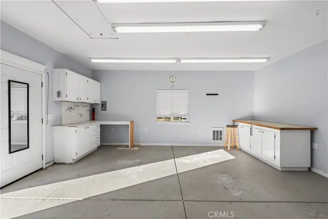 a view of a house with wooden fence