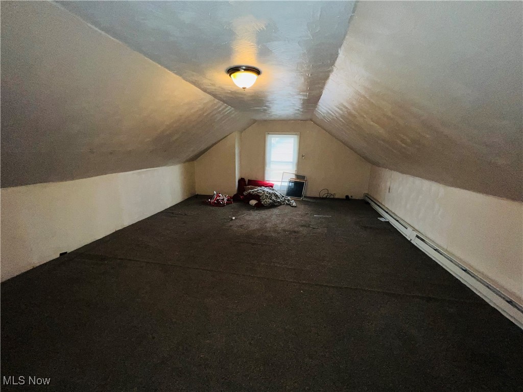 968 Whitby Road Cleveland Heights, OH 44112 - Photo 11 of 19 Additional living space with vaulted ceiling, a baseboard heating unit, a textured ceiling, and carpet floors