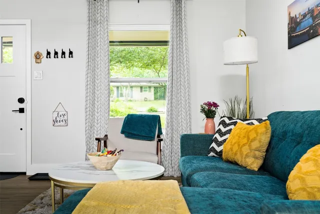 a living room with furniture and a lamp