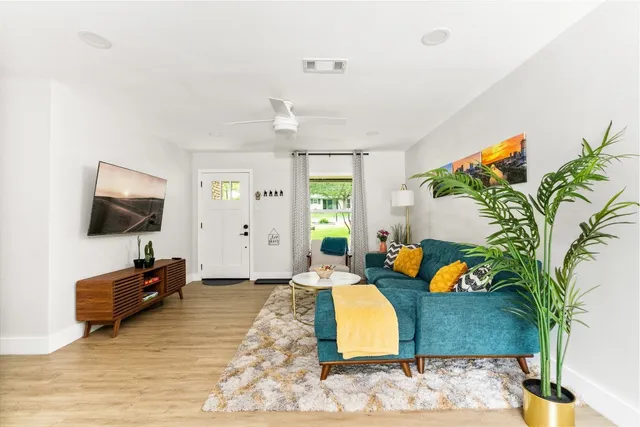 a living room with furniture and a flat screen tv