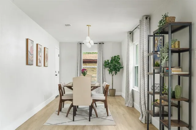 a view of a dining room with furniture and window