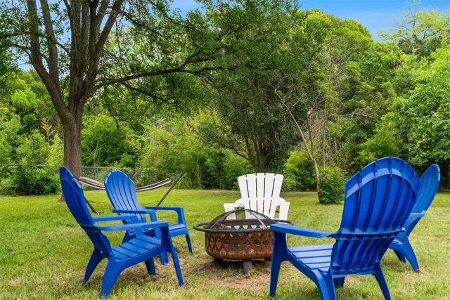 a view of a chairs in backyard of the house