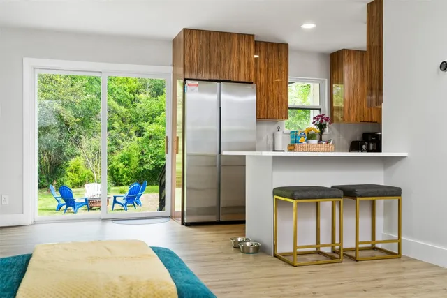 a kitchen with stainless steel appliances kitchen island granite countertop a refrigerator and stove