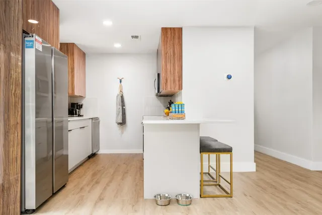 a kitchen with white cabinets and white appliances