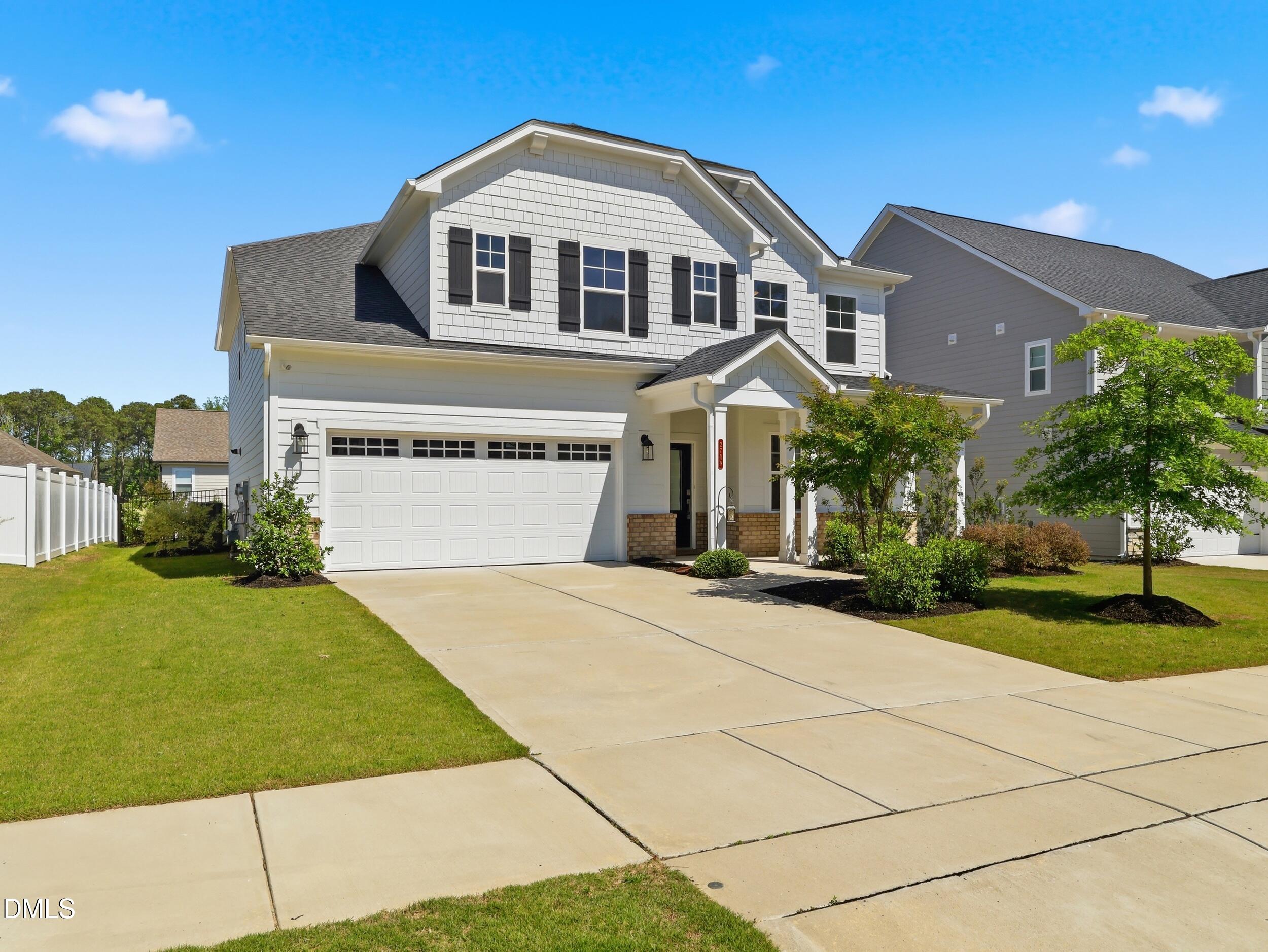 2709 Womble Ridge Drive New Hill, NC 27562 - Photo 2 of 60 a front view of a house with a yard and garage