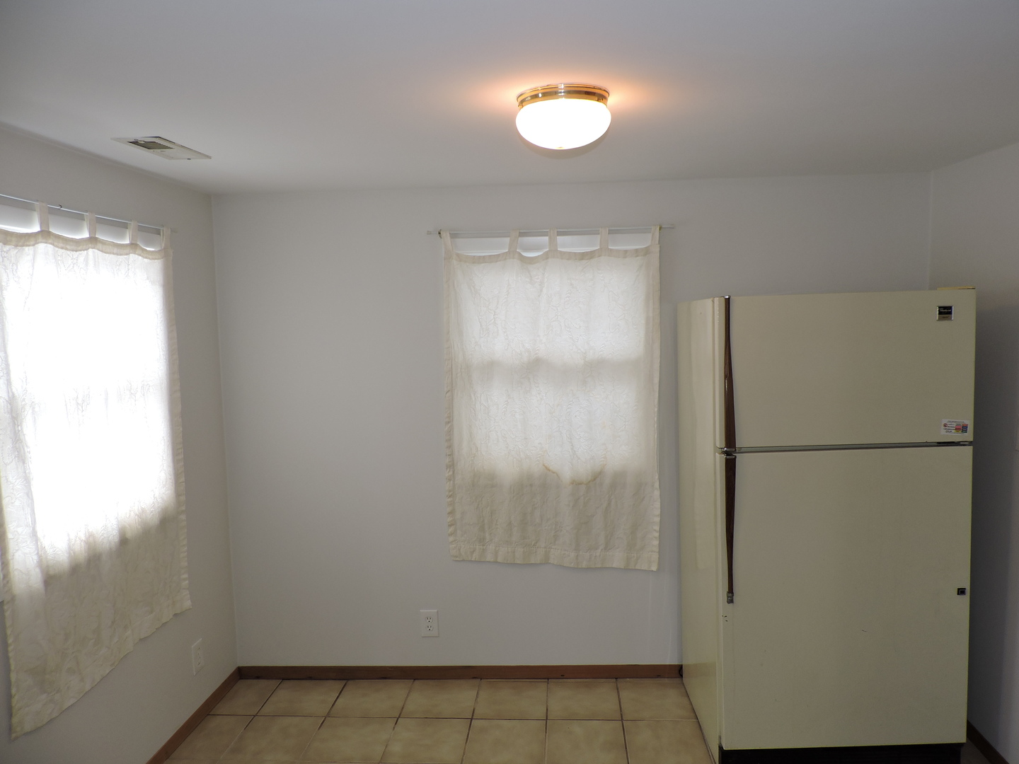 7749 79th Place Bridgeview, IL 60455 - Photo 15 of 19 a view of a refrigerator in kitchen and a window