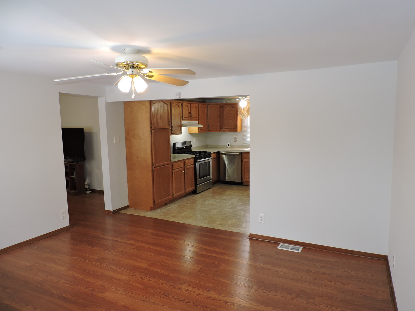 7749 79th Place Bridgeview, IL 60455 - Photo 4 of 19 a view of kitchen with granite countertop cabinets and refrigerator