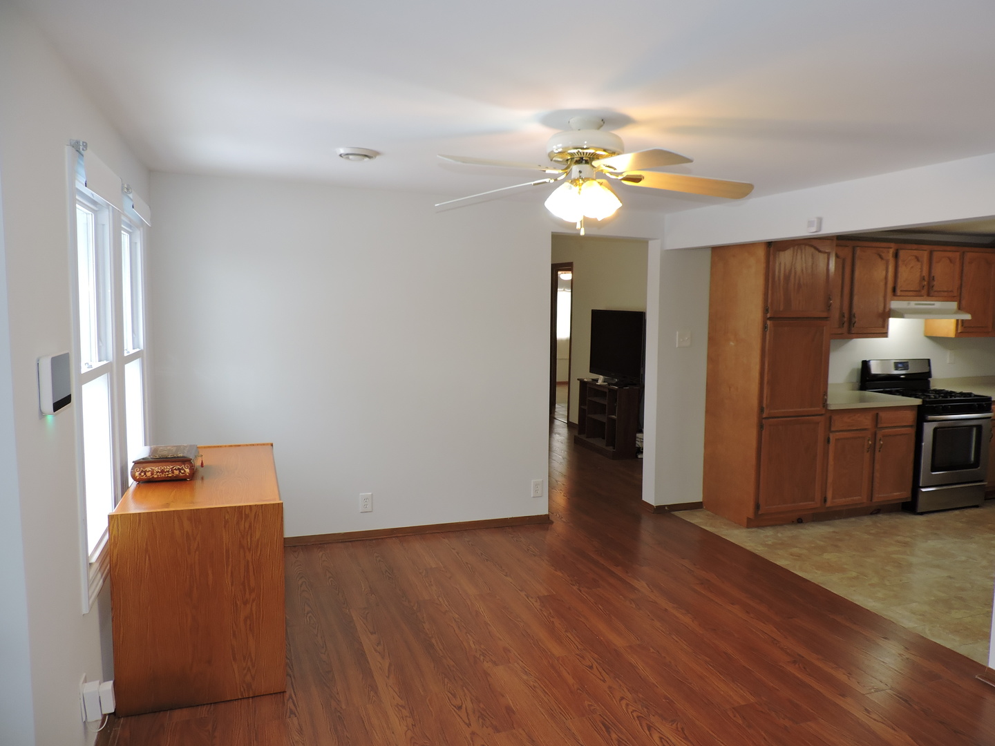 7749 79th Place Bridgeview, IL 60455 - Photo 5 of 19 a view of a kitchen with wooden floor and a refrigerator