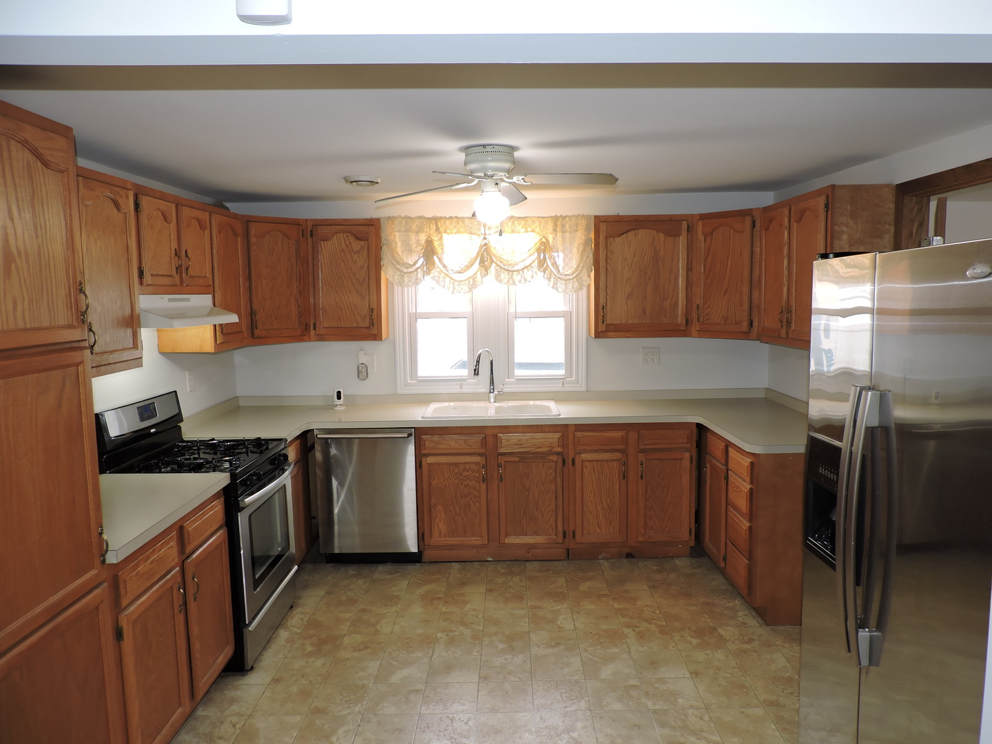 7749 79th Place Bridgeview, IL 60455 - Photo 7 of 19 a kitchen with a sink stove and cabinets