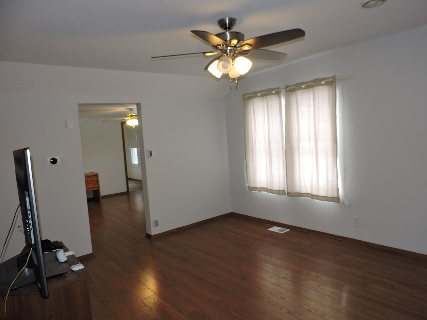 7749 79th Place Bridgeview, IL 60455 - Photo 9 of 19 wooden floor in an empty room with a window