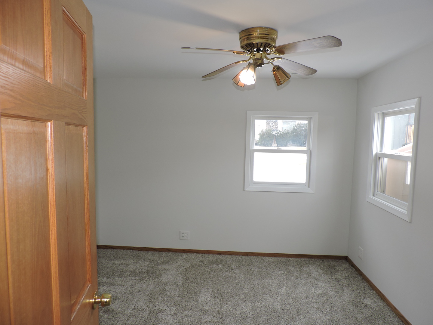 7749 79th Place Bridgeview, IL 60455 - Photo 10 of 19 an empty room with windows and fan