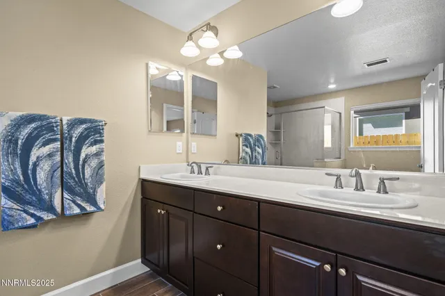 a bathroom with a double vanity sink and a mirror