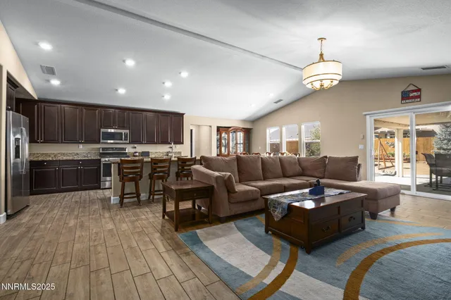 a living room with lots of furniture and kitchen view