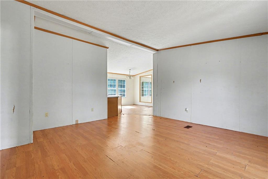 249 John Golden Road Temple, GA 30179 - Photo 13 of 45 a view of an empty room with wooden floor and a window