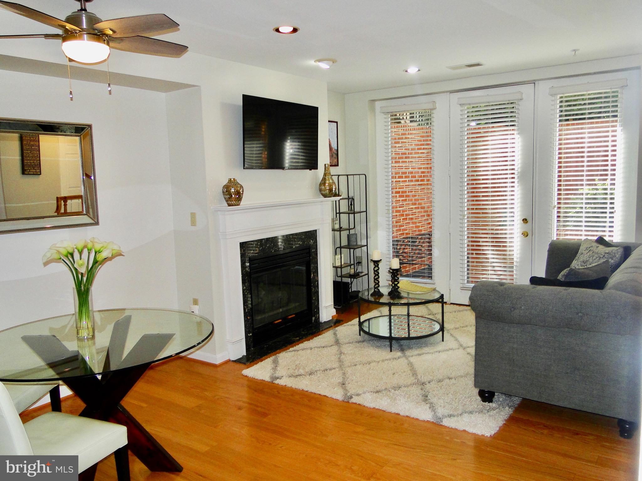 1927 Belmont Road Northwest, Unit 83 Washington, DC 20009 - Photo 8 of 27 Living room with floor to ceiling windows