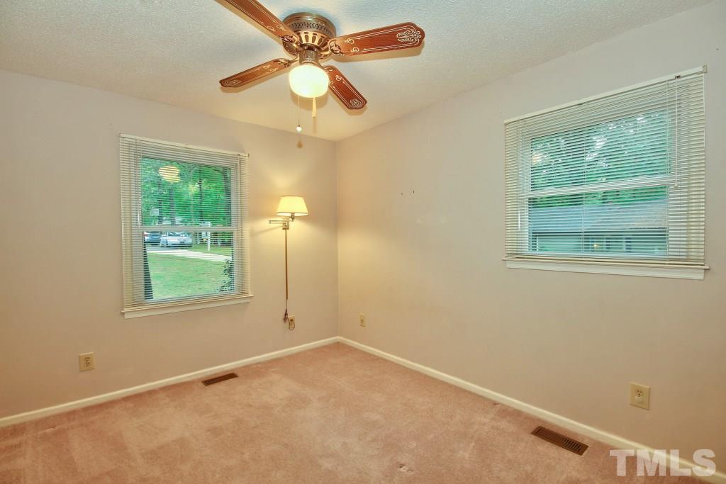 7609 Rambeau Circle Raleigh, NC 27613 - Photo 13 of 22 an empty room with a window and a fan