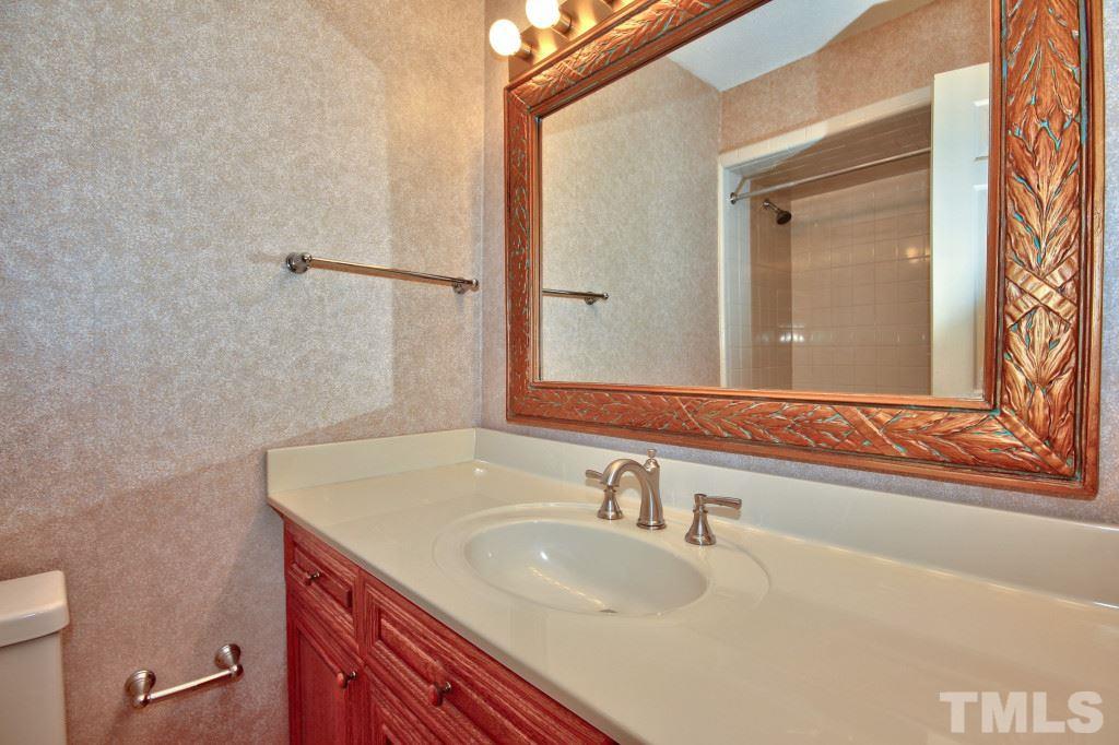 7609 Rambeau Circle Raleigh, NC 27613 - Photo 14 of 22 a bathroom with a sink and a mirror