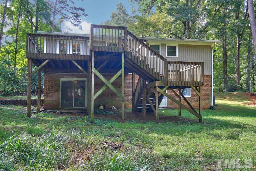 7609 Rambeau Circle Raleigh, NC 27613 - Photo 22 of 22 a view of a house with a yard and a wooden deck